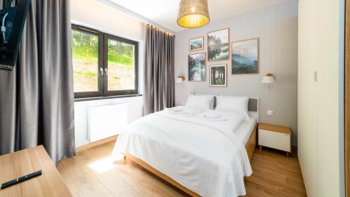 Postel nebo postele na pokoji v ubytování Karpatia, Sun & Snow