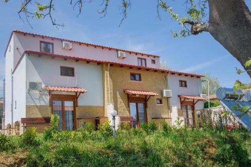 a large house with a lot of windows at 3D iliadis Suites in Ierissos