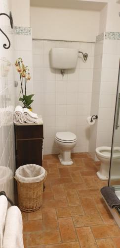 a bathroom with a toilet and a sink at Ascanio Appartamenti in Castiglione del Lago