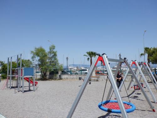 a row of playground equipment on a beach at Gardelis Gardens in Benitses