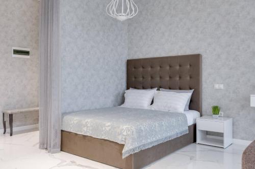 a bedroom with a large bed and a chandelier at Luxurious Apartment with panoramic view in the historic center in Kyiv