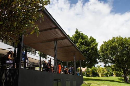 a building with a roof with people on it at Villa Internacional Hotel & Club in Cuernavaca