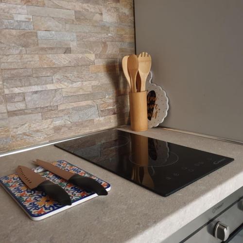 a kitchen counter with wooden utensils on a counter top at Apartment la Grotta Pizzo in Pizzo