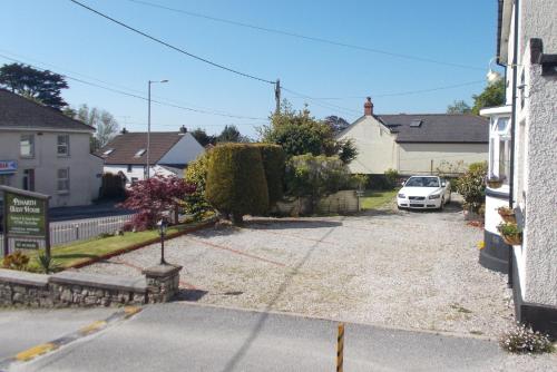 a parking lot with a car parked in a driveway at Penarth Guest House in Par