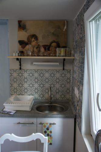 a kitchen with a sink and a counter top at Klara Apartmanház in Orfű