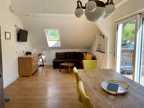 a living room with a table and a couch at Haus Gnigl in Salzburg