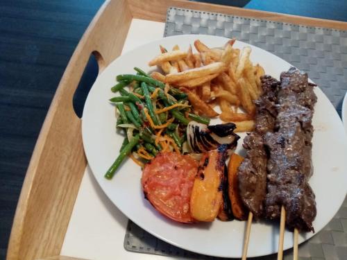 a plate of food with meat and french fries at L'ilot de Carpentras in Carpentras