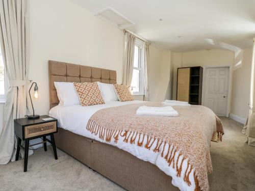 a bedroom with a large bed and a window at Laurel House in Whitby