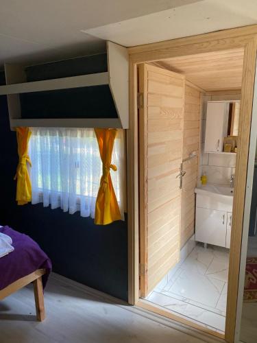 a room with a door open to a bathroom at Kara Kedi Beach Bungalow in Cıralı