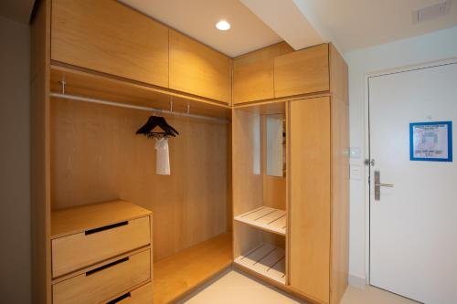 a walk in closet with wooden cabinets at The Morgan Resort Spa & Village in Simpson Bay