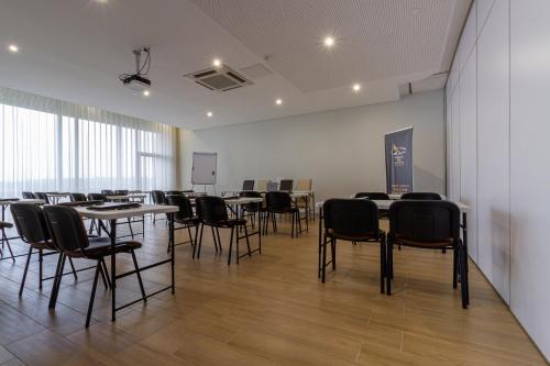 a large room with tables and chairs in it at In Gold Hotel & Spa in Águeda