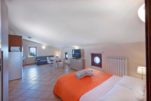 a bedroom with a bed and a kitchen and a living room at Casa Serena with sea view in Conca dei Marini