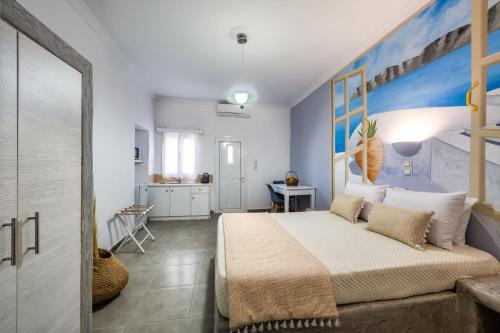 a bedroom with a large bed with a painting on the wall at Vinas Place City Center in Fira