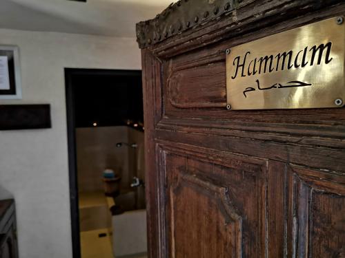 a wooden door with a sign that reads hamlin jazz at Riad Charme d'Orient Adults Only in Marrakech