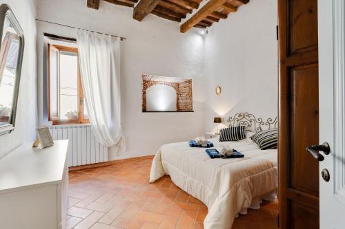 a white room with a bed and a mirror at Medieval Charm - Vicopisano Cozy Apartment in Vicopisano