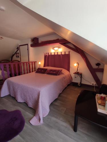 a bedroom with a large bed in a attic at Carmen&Pascal in Mareuil-sur-Cher