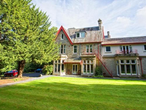 a large brick house with a large yard at Balcary House Hotel in Hawick