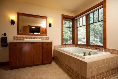 a large bathroom with a tub and a sink at 240 County Road 201 in Durango
