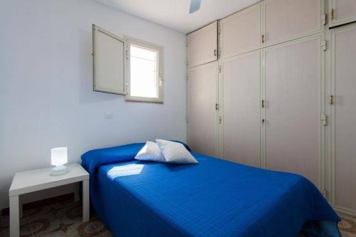 a bedroom with a blue bed and white cabinets at La Casa blu sul mare - The Blue house by the sea in Castellammare del Golfo