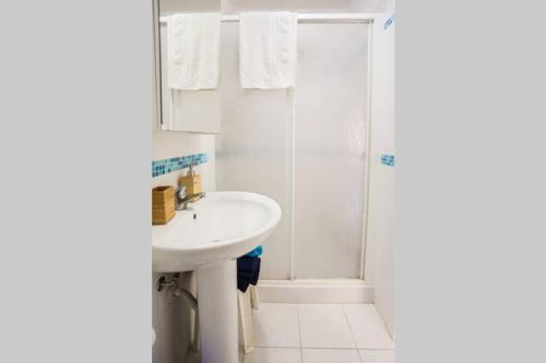 a bathroom with a sink and a shower at La Casa blu sul mare - The Blue house by the sea in Castellammare del Golfo