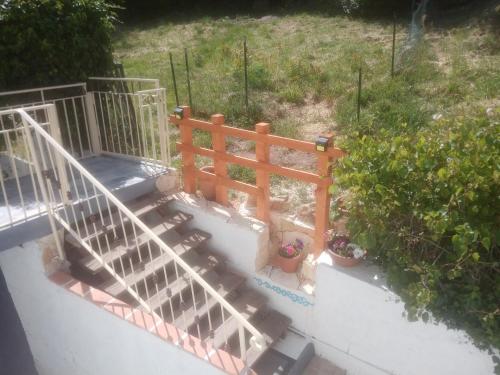 an overhead view of a wooden staircase with plants at B&B Bella Vista in Dorgali