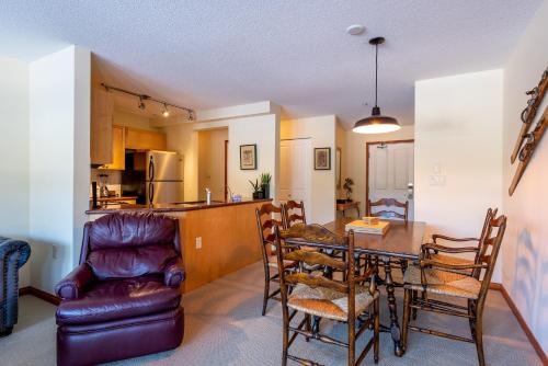 a kitchen and dining room with a table and chairs at Beautiful 2 bedroom overlooking Whistler's Green Lake and Mountains! in Whistler