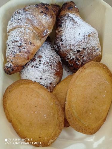 a plate of food with pastries and potatoes at AD UN PASSO DAL MARE in Praia a Mare