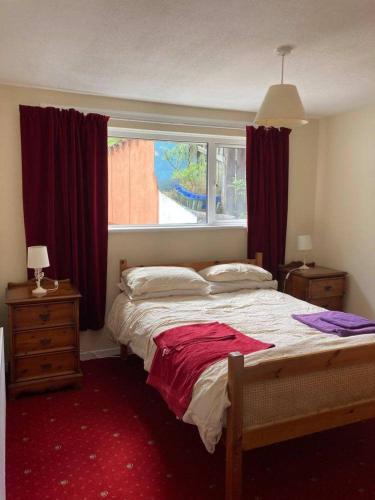 a bedroom with a large bed and a window at Channel Vista in Glenarm