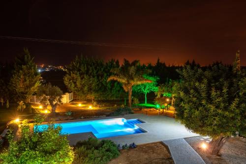 an overhead view of a swimming pool at night at Holiday's Paradise in Olhão