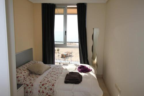 a bedroom with a bed with a view of the beach at POSTIGUET BEACH in Alicante
