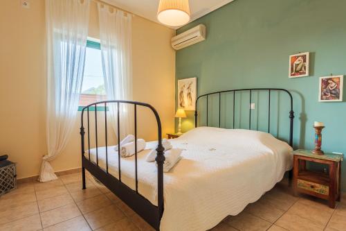 a bedroom with a bed and a window at Lavender Garden Retreat - Secluded Seaside Getaway in Kotrónion