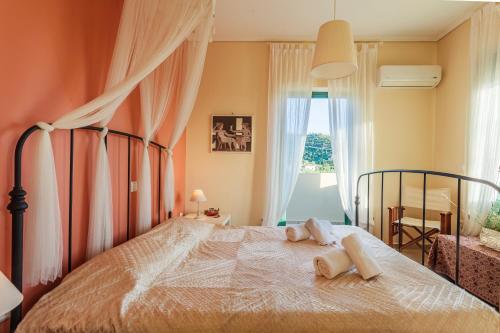 a bedroom with a bed with two towels on it at Lavender Garden Retreat - Secluded Seaside Getaway in Kotrónion