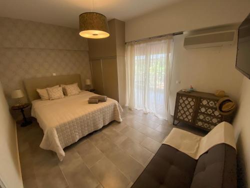 a bedroom with a bed and a large window at Tropicana in Athens