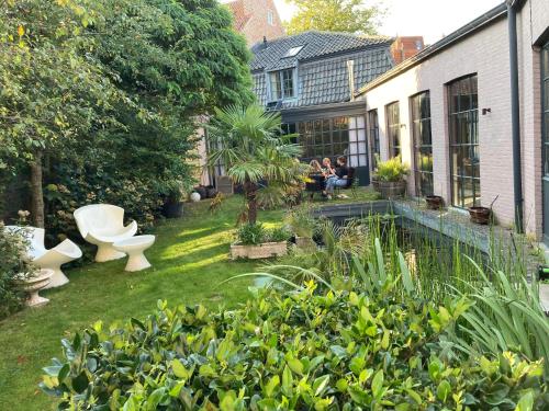 a garden with two toilets sitting in the grass at Canal Central in Bruges