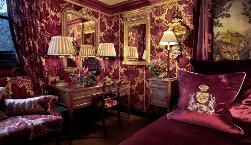 a room with a desk and a table with a mirror at Prestonfield House in Edinburgh