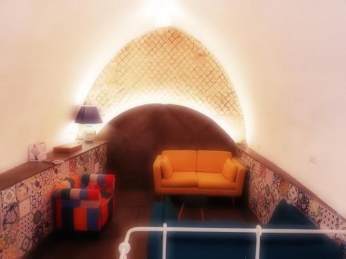 a room with a couch and a chair in a tunnel at Airone Hotel in Naples