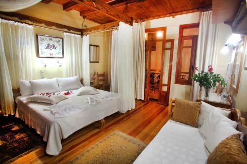 a bedroom with a large bed and a couch at Palazzo di Pietro in Chania Town