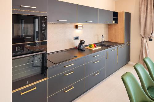 a kitchen with blue cabinets and a sink and appliances at Villa Allure in Sutivan