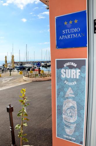 a sign on the side of a building next to a marina at Studio apartment Surf by the sea in Opatija