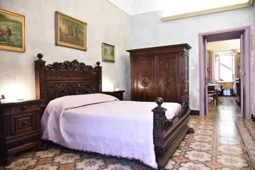 1 dormitorio con 1 cama grande con marco de madera en Casa Isabella Lilla Intero Appartamento, en Sorso