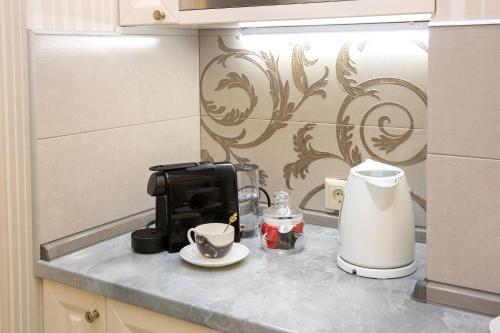 a kitchen counter with a coffeemaker and a coffee maker at Beach & Beatles Apartments in Odesa