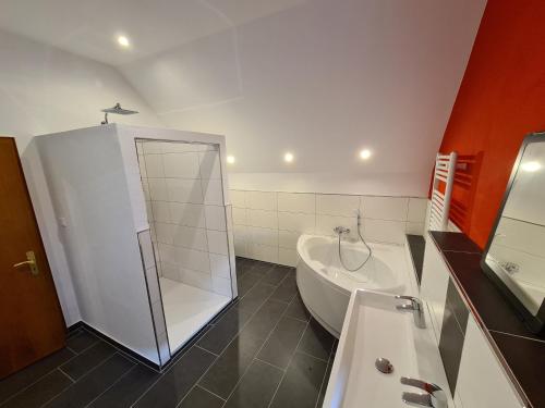ein Badezimmer mit einer Dusche, einer Badewanne und einem Waschbecken in der Unterkunft Das Baumeisterhaus - Monteurzimmer in Grünberg in Grünberg