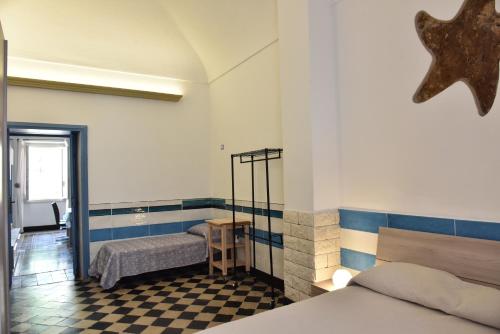 a bedroom with a bed and a checkerboard floor at Casa Isabella Light Blue Intero Appartamento in Sorso