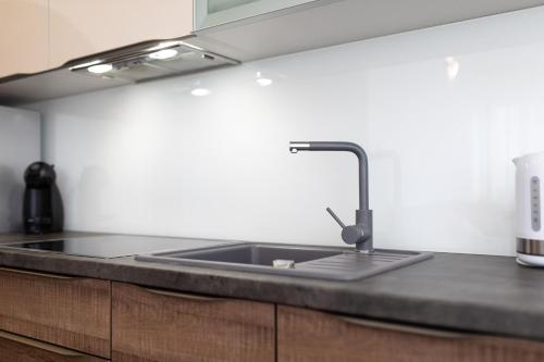 a kitchen counter with a sink in a kitchen at Apartments Stipančić in Krk