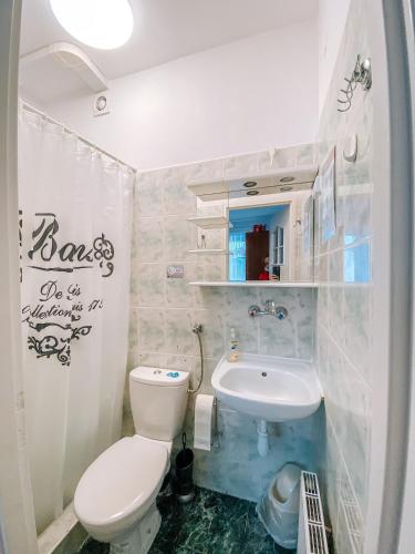 a bathroom with a white toilet and a sink at Dom na Fali Darlowko in Darlowko