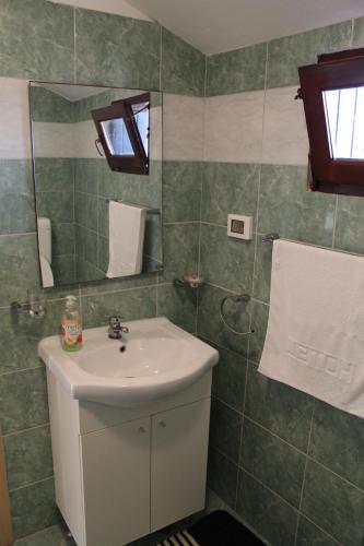 a bathroom with a sink and a mirror at Apartment Sea in Galižana
