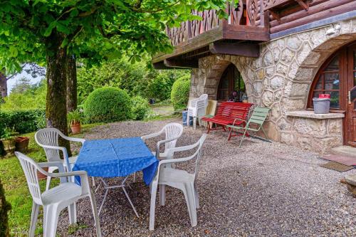 a table and chairs in front of a building at Magnificent chalet on the heights of Veyrier-du-Lac - Welkeys in Veyrier-du-Lac