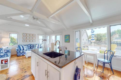 a kitchen with a sink and a living room at Sweet Haven in Boothbay Harbor