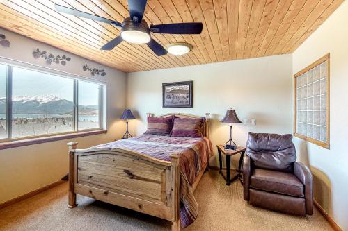 a bedroom with a bed and a ceiling fan and a chair at Dillon Dreamscape in Dillon