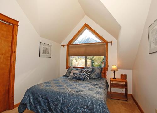 a bedroom with a bed and a window at River Park 1245 in Ouray